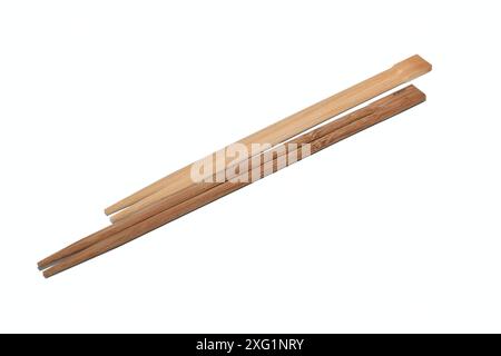 Two sets of wooden chopsticks lie on a white background. Stock Photo