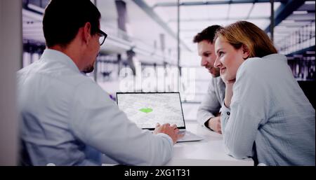 Male Real Estate Broker Explaining Development Plan To Young Couple In Urban Area, Building Trust With Hispanic Partner. Stock Photo