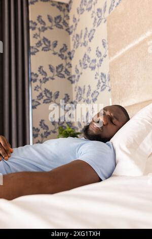 Relaxing at home, African American man sleeping peacefully on bed, copy space Stock Photo