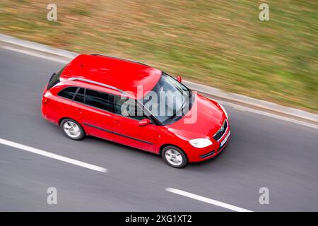 OSTRAVA, CZECH REPUBLIC - SEPTEMBER 22, 2023: Red Skoda Fabia II Combi vehicle with motion blur effect in top view Stock Photo