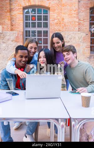 Group of students, prepare for university exams, use a laptop.Vertical Stock Photo