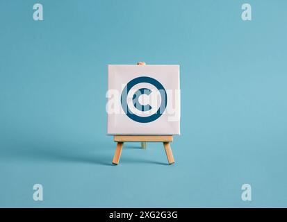 A canvas with copyright symbol on an easel with blue background. FAQ, confusion, uncertainty, to ask a question and query concepts. Stock Photo