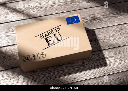 Cardboard box with made in EU stamp and European union flag on wooden planks background. Concept of exporting goods from the EU around the world. 3D r Stock Photo