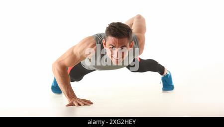 Strong man perform biceps and triceps workout at home without equipment Stock Photo