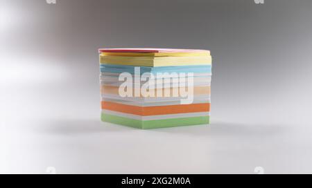 Uneven stack of sticky post it notes on grey surface, bunch of clean papers Stock Photo