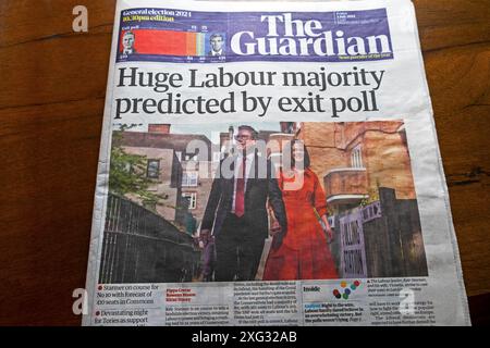'Huge Labour majority predicted by exit poll' Guardian newspaper headline front page 5 July 2024 Keir Starmer PM election article London  UK Britain Stock Photo