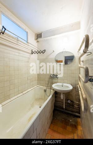 Bathroom in bad condition in an abandoned building. Abandoned house interior. Dirty Room. Old Soviet Russian Poor Interior. Stock Photo