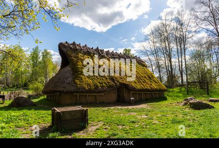 A replica of a beautiful longhouse standing proud under a blue sky outside Falköping in Sweden. Stock Photo