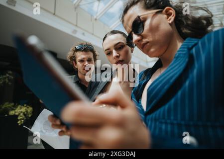Focused business team discussing project details in a modern office environment Stock Photo