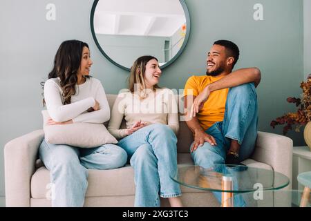 Multi ethnic group of friends relaxing on student accommodation Stock Photo