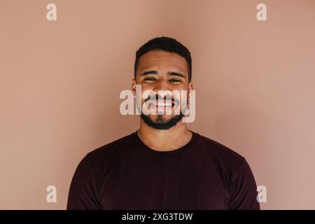 Male portrait of young latin (african american) adult looking at camera with a natural smile Stock Photo
