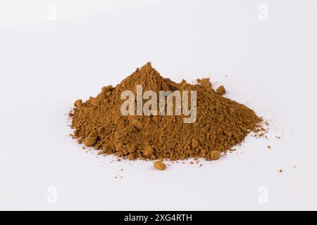 dark ocher pigment on a white background Stock Photo - Alamy