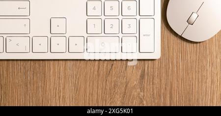Keyboard from a computer and a computer mouse on a desk in the B Stock Photo