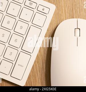 Keyboard from a computer and a computer mouse on a desk in the B Stock Photo