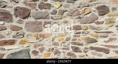 Old natural stone wall on a historic building Stock Photo