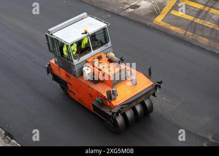 Vibrating roller working on Road construction. Asphalt paving. High angle view Stock Photo