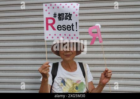 Tokyo, Japan. 06th July, 2024. A Japanese woman holds a flag saying 'reset' as she attends a speech by candidate, Renho on the last day of campaigning for the 2024 Tokyo Gubernatorial elections. A record 56 candidates are standing in the election on July 7th the strongest challenge for the incumbent, Yuriko Koike, (who is hoping to win a third term as governor of Japan's capital city) coming from centre-left politician, Renho Saito. Credit: SOPA Images Limited/Alamy Live News Stock Photo