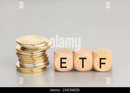 Cryptocurrency ETF concept. Stacked crypto coins and wooden blocks with text. Copy space Stock Photo