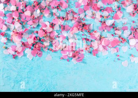 Valentine day or wedding background with hearts confetti on blue, shot from the top with a place for text, a romantic banner Stock Photo