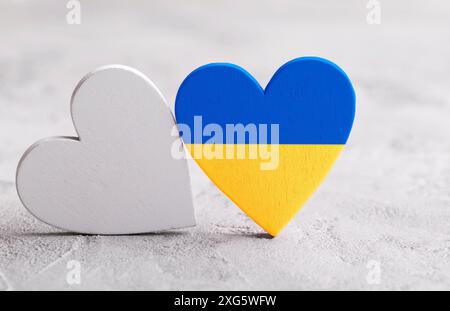 Heart with Ukrainian flag colors on the grey stone background. Stop the war in Ukraine Stock Photo