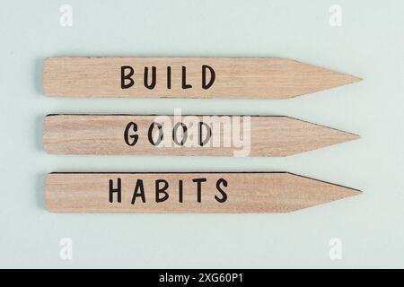 The words build good habits are standing on arrows, change lifestyle, healthy and positive attidude, motivation concept Stock Photo