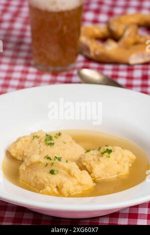 Bavarian dumpling soup on tablecloth Stock Photo