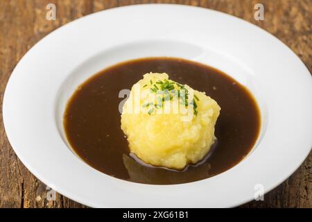 Bavarian dumpling in a plate with sauce Stock Photo