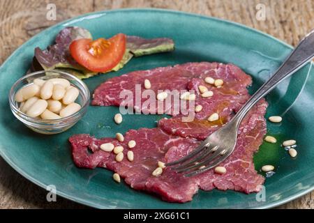 Italian carne salada on a green plate Stock Photo