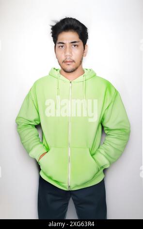 Asian man portrait in hoddy cassual shirt looking camera on studio shot to present blank hoody shirt Stock Photo