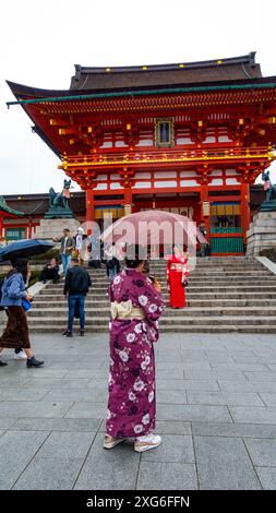 JAPAN, KYOTO – April 2024: young girl dressed with kimono at Fushimiinari Taisha Shrine Temple in Kyoto, Japan Stock Photo