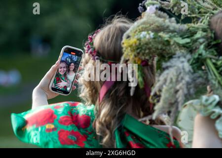 Moscow, Russia. 6th of July, 2024. Girls in wreaths of wildflowers are seen during a celebration of the Belarusian holiday 'Kupalle' in Ostankino Park in Moscow, Russia. Kupalle or Ivana Kupala Day, also known as Ivana-Kupala or Kupala Night, is a traditional pagan holiday folk celebration in eastern Slavic cultures. Girls create and wear flower wreaths and perform various rituals. Initially, Ivana-Kupala was a pagan fertility rite that was also connected to the celebration of the summer solstice when nights are the shortest Stock Photo