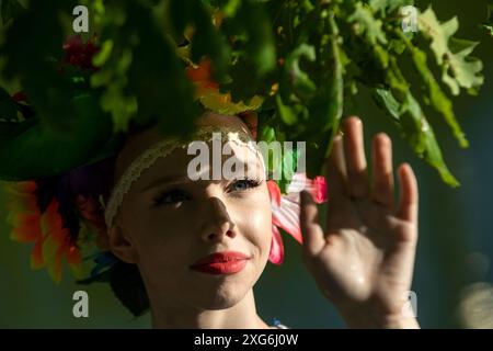 Moscow, Russia. 6th of July, 2024. Girls in wreaths of wildflowers are seen during a celebration of the Belarusian holiday 'Kupalle' in Ostankino Park in Moscow, Russia. Kupalle or Ivana Kupala Day, also known as Ivana-Kupala or Kupala Night, is a traditional pagan holiday folk celebration in eastern Slavic cultures. Girls create and wear flower wreaths and perform various rituals. Initially, Ivana-Kupala was a pagan fertility rite that was also connected to the celebration of the summer solstice when nights are the shortest Stock Photo