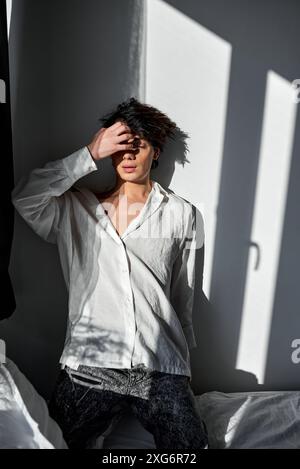Portrait of young sleepy man with hangover feeling headache closing eyes . Headache, drug and alcoholism addiction, human bad habits. Morning after a Stock Photo