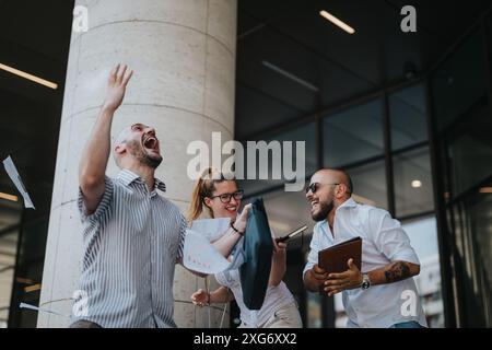 Businesspeople celebrating a successful meeting outdoors in urban downtown area Stock Photo