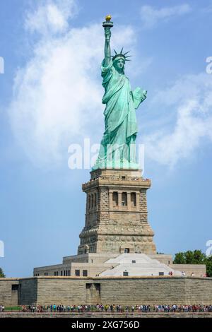 The iconic Statue of Liberty on Liberty Island. The copper clad statue is a figure of Libertas, the Roman goddess of liberty, holding a torch above he Stock Photo