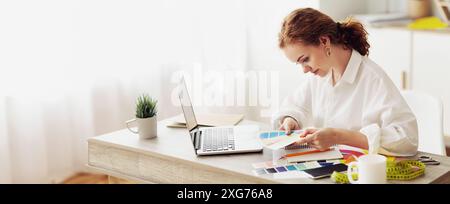 Designer atelier. Dressmaker choosing color samples for new collection Stock Photo