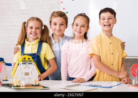 Smiling Students Working On Robotics Project In Classroom Stock Photo