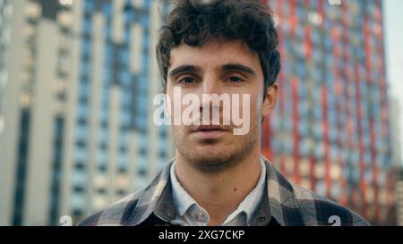 Outdoor portrait Caucasian 30s man tourist close up male businessman entrepreneur millennial real estate agent client in city business downtown Stock Photo
