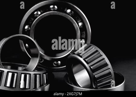 roller bearings on a black background, blank for creativity. Parts for machines and mechanisms in rotation units. Close-up selective focus copy space Stock Photo