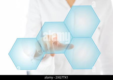 Person touching an hexagonal button on a digital interface Stock Photo