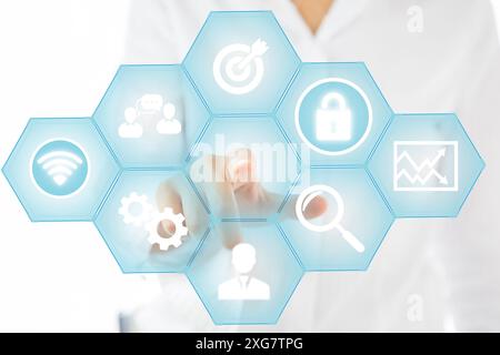 Woman pressing start button on digital screen with communication network icons Stock Photo