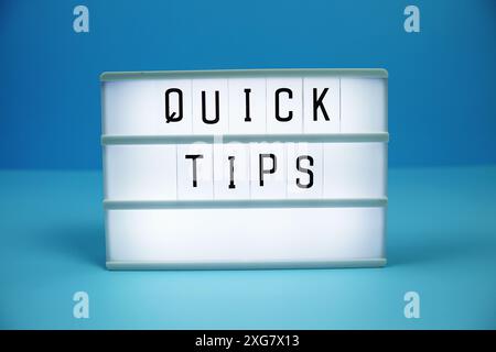 Quick Tips letterboard text on LED Lightbox on blue background Stock Photo