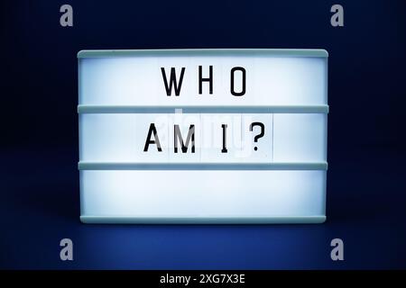 Who am I letterboard text on LED Lightbox on blue background Stock Photo