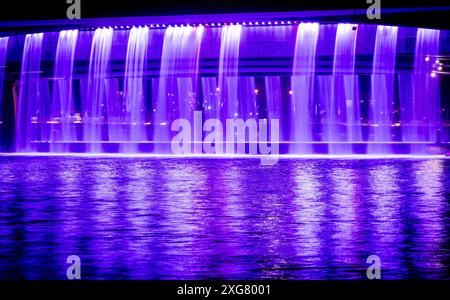 A bridge that turns into a fountain at night in Dubai Stock Photo