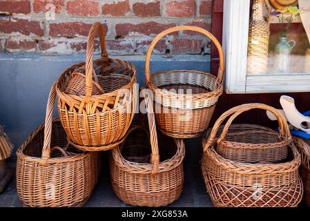 different woven, wicker baskets on the ground. A basket made of twigs. Stock Photo