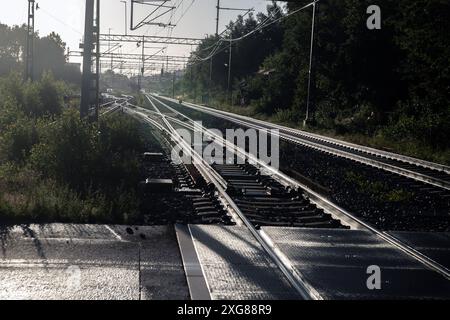 Railway tracks with electric overhead cables Stock Photo