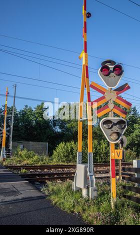 Signals and open road barrier at railway crossing Stock Photo