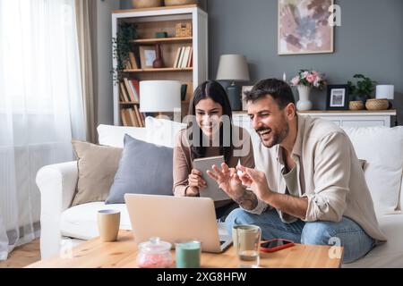 Successful young business people working together in home office. Couple teamwork startup concept video call presentation on laptop computer and webca Stock Photo