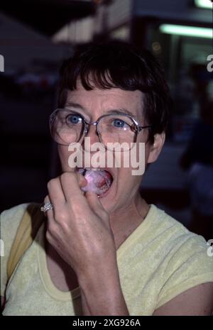 Pomona CA USA. Los Angeles County Fair. 1983.  Enjoying cotton candy and a 1880s pioneer home docent. Stock Photo