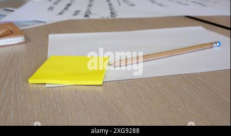 Sticky notes, papers and a pencil during a brainstorming session at a business workshop Stock Photo